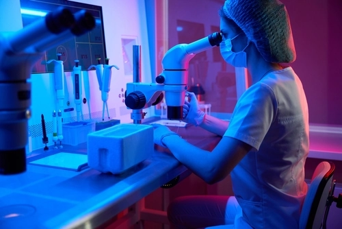 Female embryologist works with biomaterial for cryopreservation